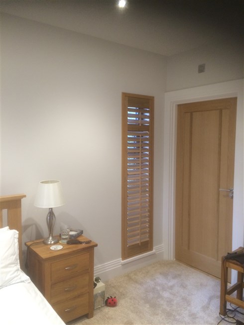 Wooden plantation shutters give you the option of matching your window coverings with your furniture, such as these beautiful White Teak shutters stained to Medium Oak, fitted in Northumberland.